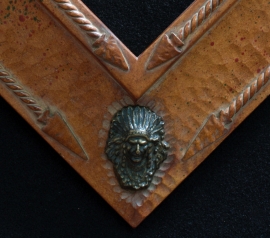 Bronze Indian Mirror Frame Detail Hand carved 5 inch wide x 2 inch tall, wood tone finish with bronze Indian heads in corners, Arrow head accents