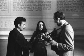 Bob Dylan, Joan Baez and Paul Stookey singing inside the Lincoln Memorial. August 28, 1963. Price on request.
